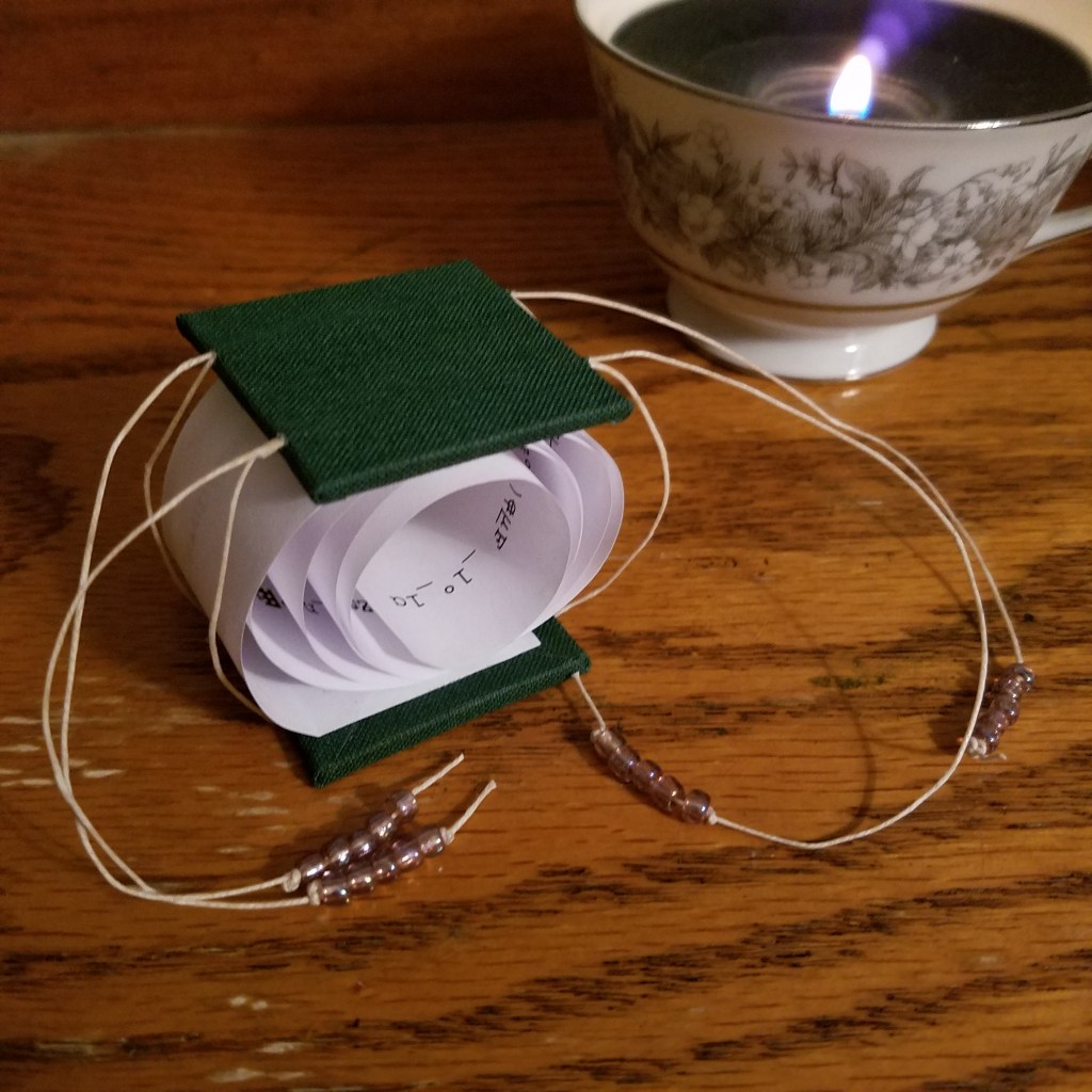 The drawstring coil book sits closed on a table.